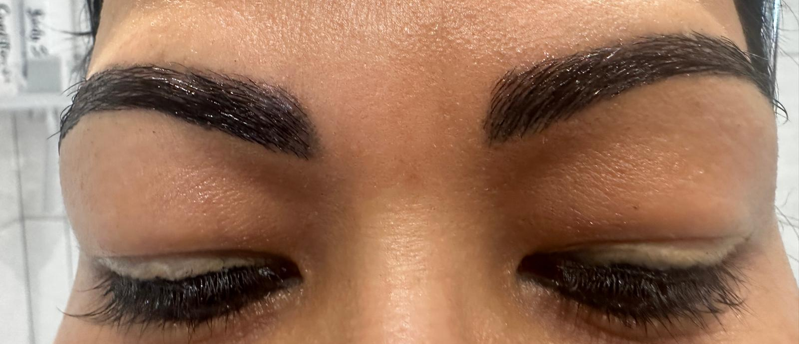 Close-up of both eyebrows and closed eyes
